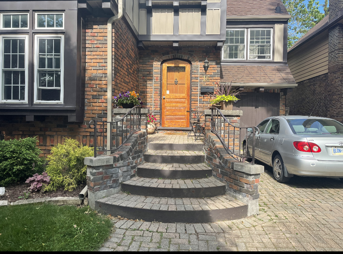 Front entrance before renovation with aged brick steps, mismatched mortar, and worn paver walkway in London Ontario